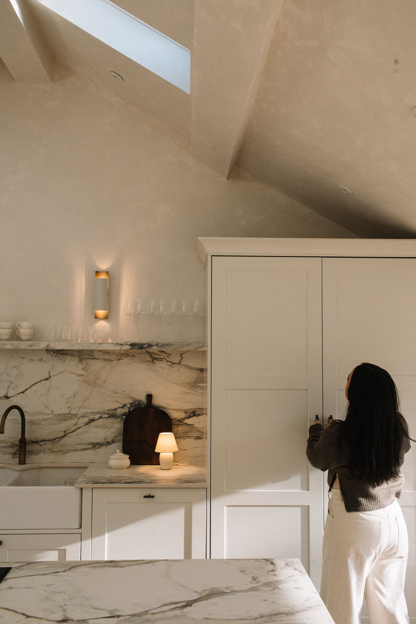Kitchen cabinetry beneath a skylight