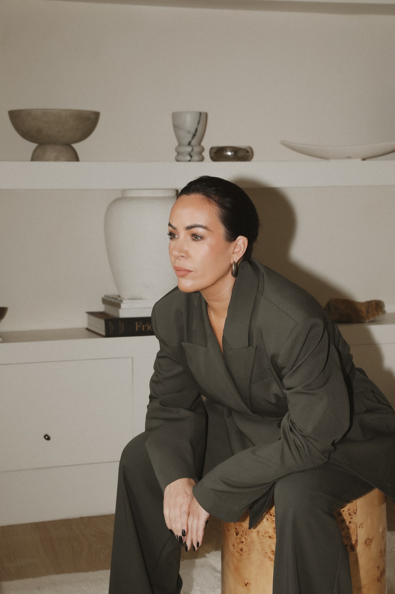 Gemma Lomas-Jones seated, in a tailored suit
